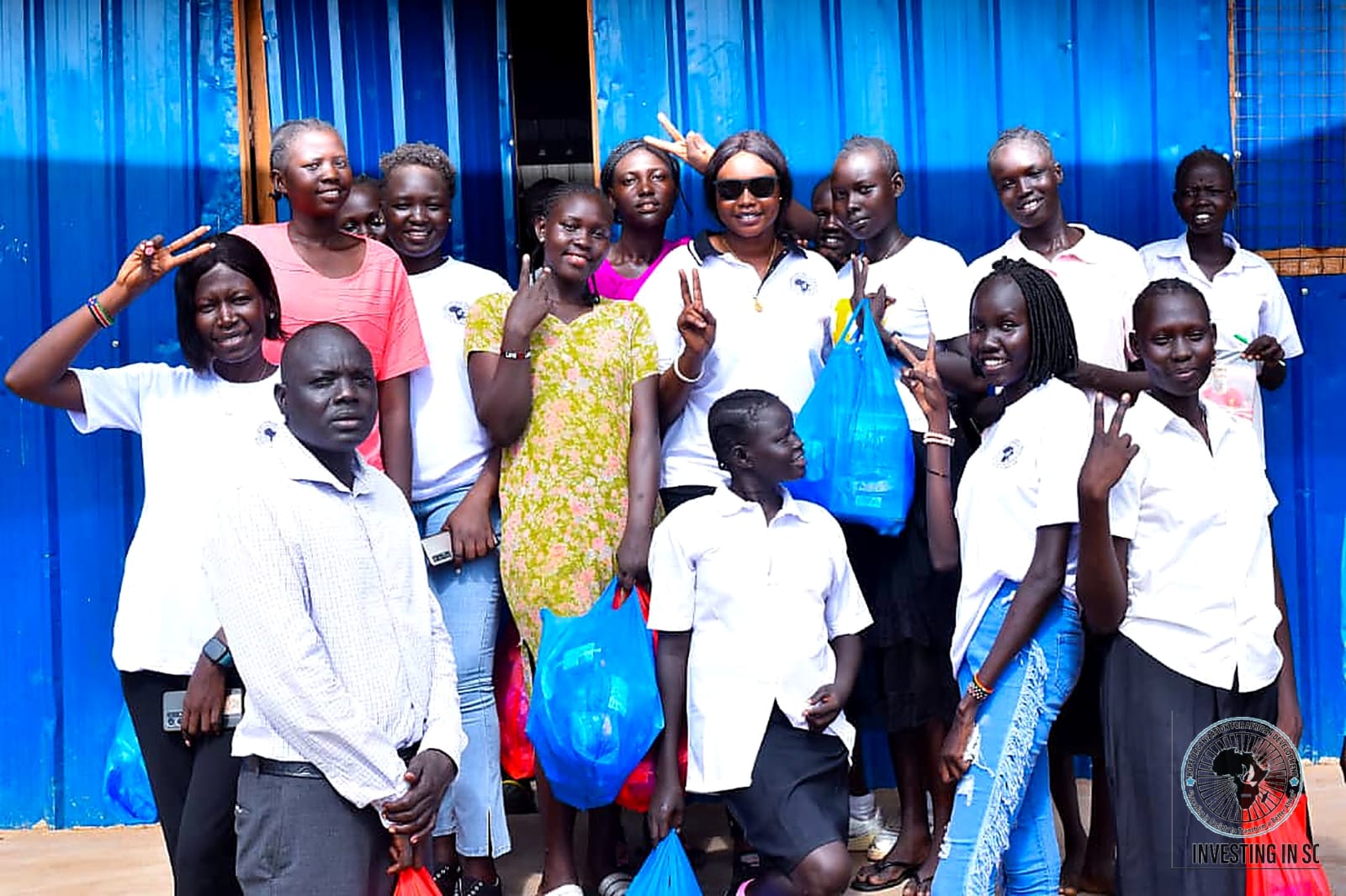 Girls at a school receiving supplies from HOFAD